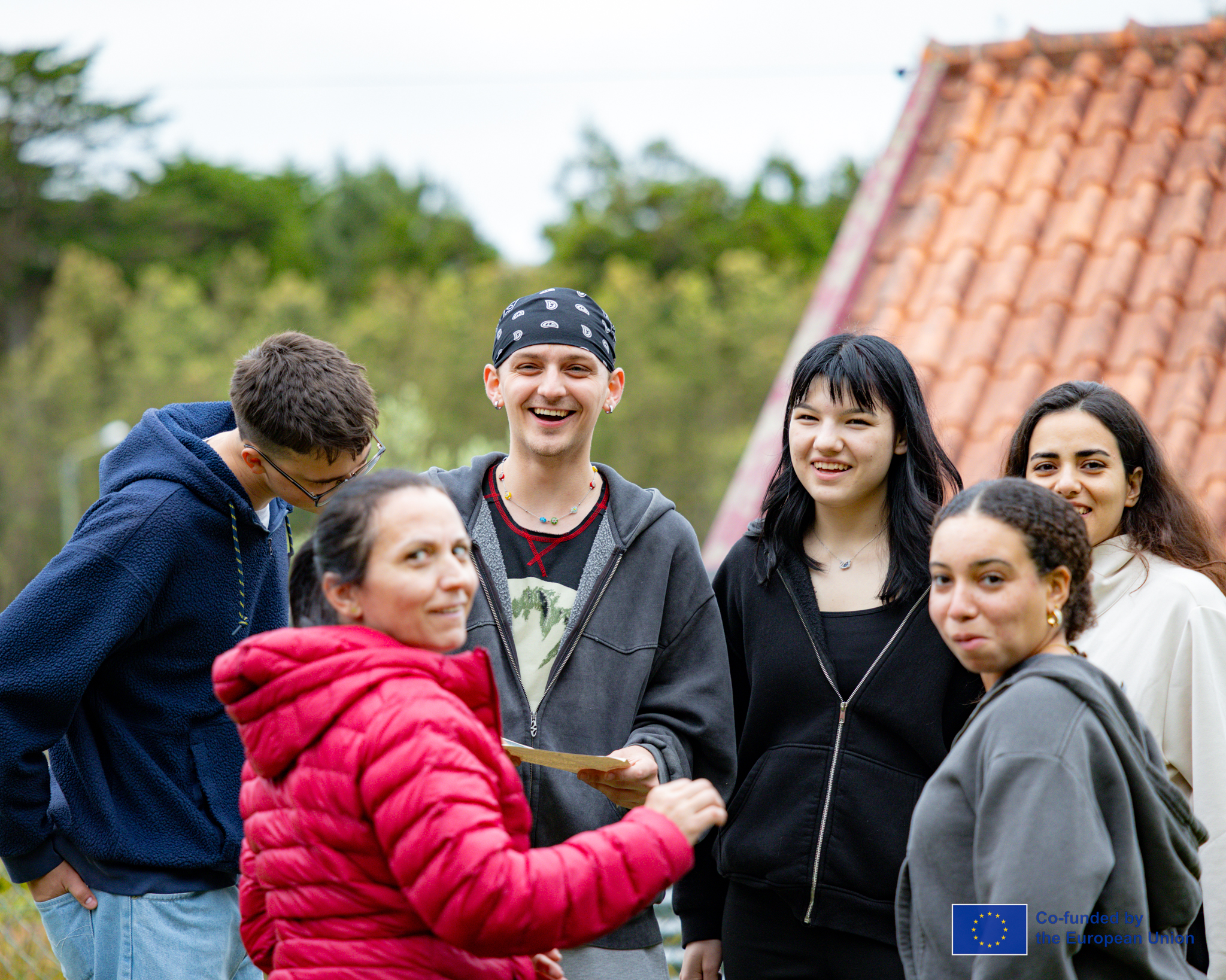 Young people gathered outdoors for a collaborative cultural exchange session.